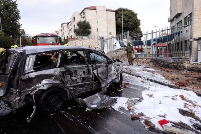  The remains of a destroyed vehicle are seen on a road after a rocket, launched from the Gaza Strip landed in the Israeli settlement of Beitar Ilit, in the West Bank October 9, 2023. (credit: REUTERS/Ronen Zvulun)