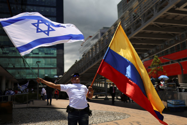  A supporter of Israel holds flags during a protest, following Hamas' biggest attack on Israel in years, in Bogota, Colombia October 9, 2023. (credit: REUTERS/LUISA GONZALEZ)