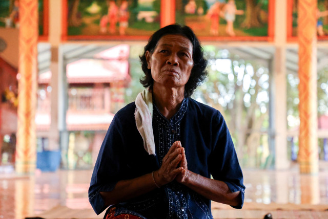  Noopar Pansa-ard, 63, prays for her son, Somkuan Pansa-ard, 39, a Thai labour who was killed in Israel in the ongoing conflict between Israel and the Palestinian Islamist group Hamas, at a temple in Kalasin province, Thailand, October 11, 2023. (credit: REUTERS/Thomas Suen)