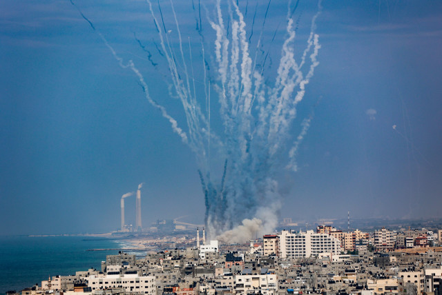  Rockets are fired from Gaza towards Israel, as it seen from Gaza City, on October 11, 2023 (credit: ATIA MOHAMMED/FLASH90)