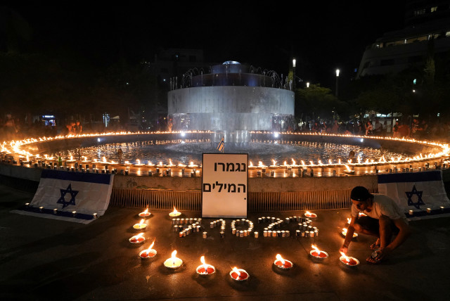  People gather and light candles to show solidarity with Israel and remember the victims following an attack by Hamas terrorists from Gaza, at Dizengoff square in Tel Aviv, Israel October 12, 2023. (credit: REUTERS/JANIS LAIZANS)