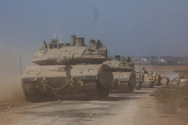  Israeli tanks and military vehicles take position near Israel's border with the Gaza Strip, in southern Israel, October 13, 2023. (credit: REUTERS/VIOLETA SANTOS MOURA)