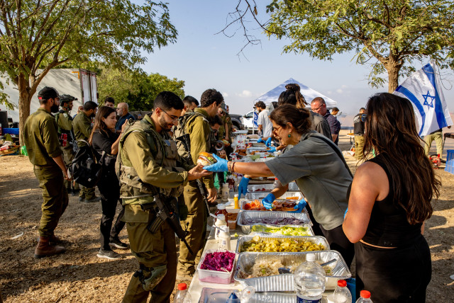  Israelis hand out food to Israeli soldiers near the border with the Gaza Strip, southern Israel, October 11, 2023 (credit: OREN BEN HAKOON/FLASH90)