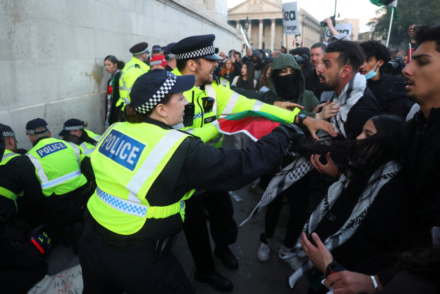  Police officers clash with demonstrators as they protest in solidarity with Palestinians, amid the ongoing conflict between Israel and the Palestinian terrorist group Hamas, in London, Britain, October 14, 2023.  (credit: REUTERS/TOBY MELVILLE)