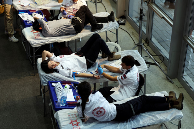  People donate blood as part of a blood-drive following a mass-rampage by armed Palestinian infiltrators into Israel, in Jerusalem October 9, 2023.  (credit: REUTERS/Ronen Zvulun)