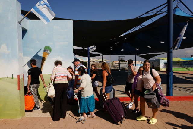  People queue as Israelis are evacuated from the southern town of Sderot, near Israel's border with Gaza, October 15, 2023 (credit: REUTERS/AMIR COHEN)