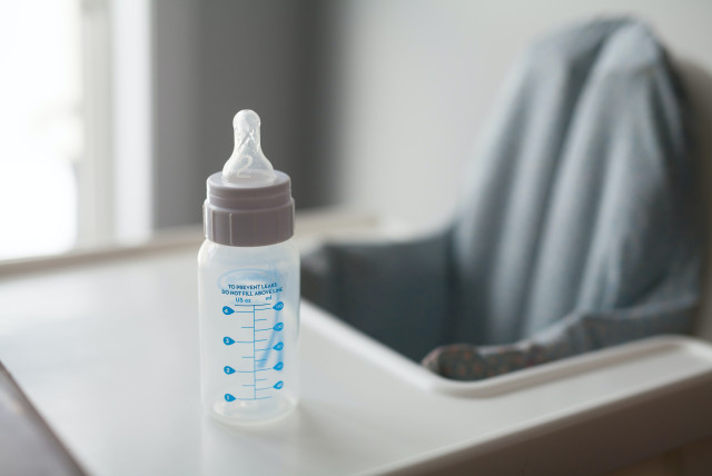  An empty baby milk bottle sits on a high chair. (credit: PEXELS)