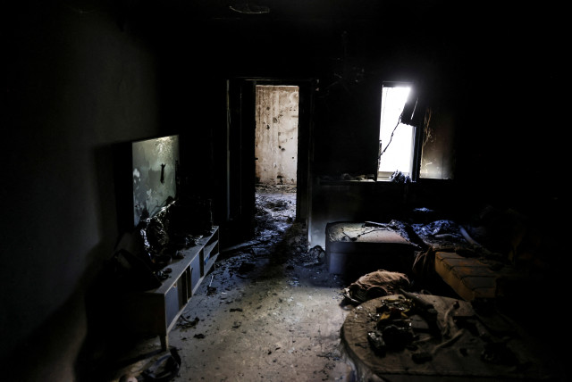  A view shows the living room of a burnt house, following a deadly infiltration by Hamas gunmen from the Gaza Strip, in Kibbutz Kfar Aza in southern Israel, October 15, 2023.  (credit: RONEN ZVULUN/REUTERS)