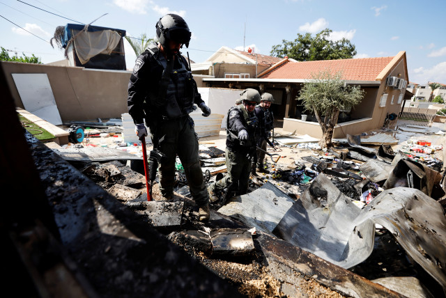 Israeli police explosive experts survey the remains of a private house after it was hit by a rocket launched from the Gaza Strip into Israel, in Sderot, southern Israel October 15, 2023. (credit: REUTERS/AMIR COHEN)