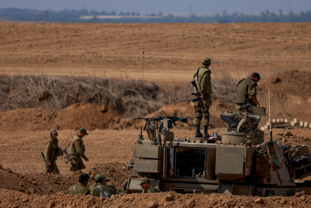  Israeli soldiers seen at a staging area near the southern Israeli border with Gaza, October 12, 2023. (credit: Chaim Goldberg/Flash90)