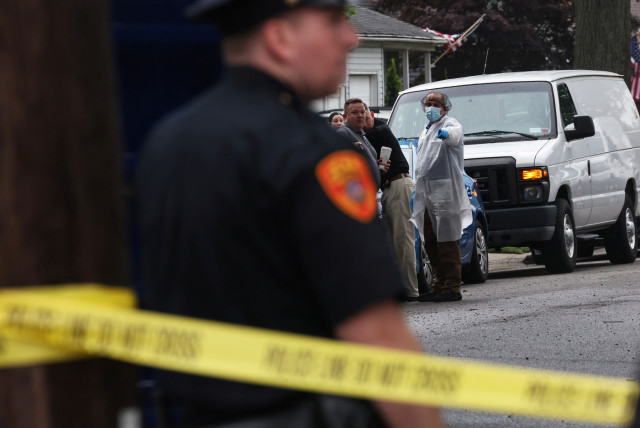  Crime scene investigators gather outside a crime scene.  (credit: REUTERS/SHANNON STAPLETON)