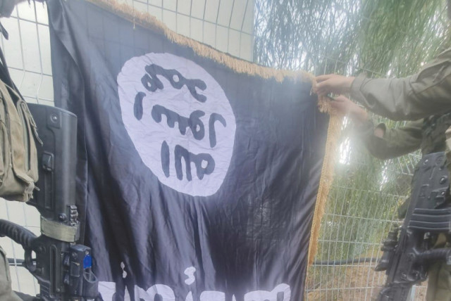  AN ISIS FLAG is left behind at Kibbutz Sufa after this month’s massacre was carried out by infiltrating Hamas terrorists. (credit: IDF SPOKESPERSON'S UNIT)