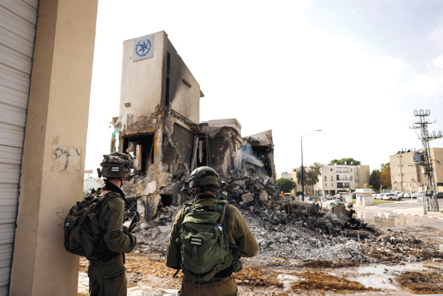  IDF soldiers inspect the remains of a police station in Sderot, which was the site of a battle following a mass infiltration by Hamas gunmen from the Gaza Strip, on October 8.  (credit: RONEN ZVULUN/REUTERS)