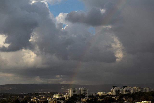 An Israeli military Apache helicopter flies near Israel's border with Lebanon while a rainbow seen in the sky in northern Israel, October 19, 2023 (credit: LISI NIESNER/ REUTERS)