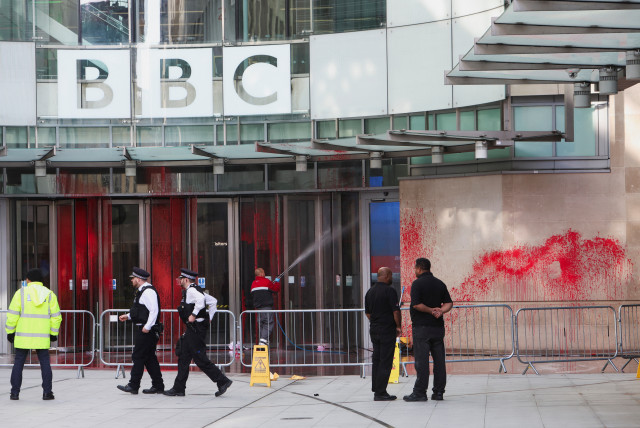 Police officers walk outside the BBC building, near where a march for a protest in solidarity with Palestinians is set to begin, covered in red paint, amid the ongoing conflict between Israel and the Palestinian Islamist terrorist group Hamas, in London, Britain, October 14, 2023. (credit: REUTERS/Susannah Ireland)