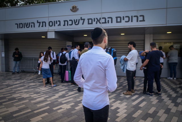  Ultra-Orthodox Jewish men who decided to join in the IDF following the ongoing war between Israel and Hamas arrive at the IDF recruiting offices in Tel Hashomer, near Tel Aviv, October 23, 2023 (credit: AVSHALOM SASSONI/FLASH90)