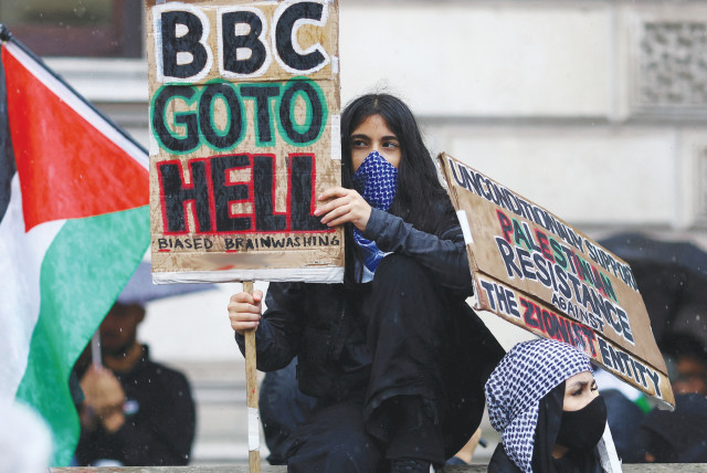  A PRO-PALESTINIAN protester blasts the BBC after it admitted it was wrong to blame Israel for the Al-Ahli Hospital explosion, while another sign calls for ‘Resistance against the Zionist entity,’ in London. (credit: REUTERS/HANNAH MCKAY)