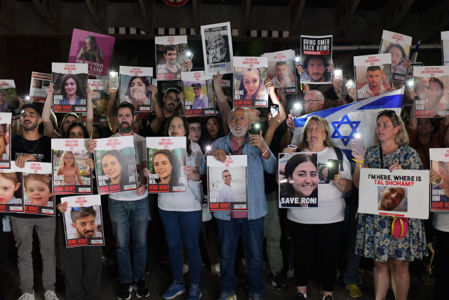  Families of Israelis held hostage by Hamas terrorists in Gaza hold up photographs of their abducted family members, at  ''Hostage Square'', outside the Art Museum of Tel Aviv, October 21, 2023 (credit: TOMER NEUBERG/FLASH90)