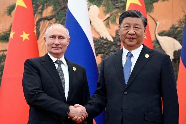 Russian President Vladimir Putin shakes hands with Chinese President Xi Jinping during a meeting at the Belt and Road Forum in Beijing, China, October 18, 2023.  (credit: Sputnik/Sergei Guneev/Pool via REUTERS)