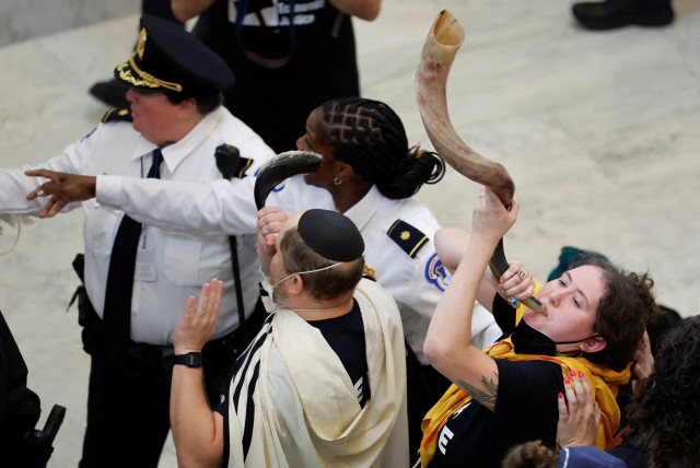  Protestors continue to blow on shofars as they are grabbed and detained by U.S. Capitol police officers during a civil disobedience action organized by Jewish Voice for Peace, calling for a cease fire in Gaza, in Washington, U.S., October 18, 2023. (credit:  REUTERS/Jonathan Ernst/Pool)