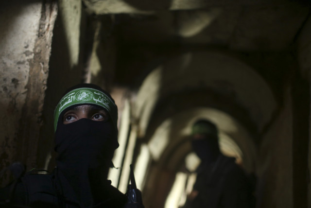  Palestinian terrorists from the Izz el-Deen al-Qassam Brigades, the armed wing of the Hamas movement, stand inside an underground tunnel in Gaza August 18, 2014.  (credit: REUTERS/MOHAMMED SALEM)