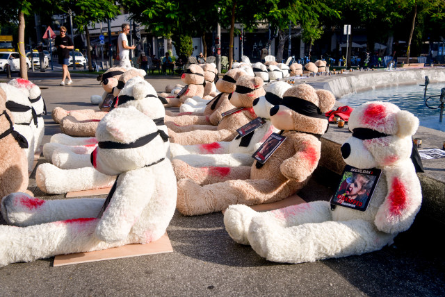  LARGE TEDDY bears with splotches of red paint and the photographs of the children held hostage by Hamas terrorists in Gaza are displayed at Tel Aviv’s Dizengoff Square on October 25 (credit: AVSHALOM SASSONI/FLASH90)