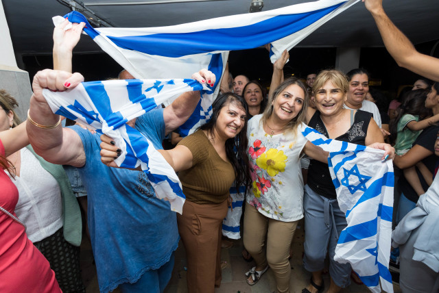  Israelis celebrate the rescue of IDF soldier Pvt. Ori Megidish from Hamas captivity, outside her home in Kiryat Gat, October 30, 2023.  (credit: LIRON MOLDOVAN/FLASH 90)