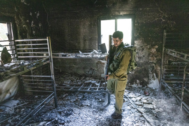  Israeli soldier around the destruction caused by Hamas terrorists in Kibbutz Nir Oz on October 7, 2023, near the Israeli-Gaza border, in southern Israel, October 30, 2023 (credit: Chaim Goldberg/Flash90)