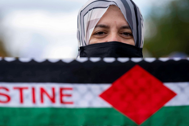  A woman looks on during a rally held by American Muslims for Palestine calling for a cease fire in Gaza in Washington, U.S., October 21, 2023 (credit: REUTERS/BONNIE CASH)