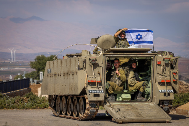  Israeli soldiers with Israeli flags near the Israeli border with Lebanon, northern Israel, November 2, 2023 (credit: David Cohen/Flash90)