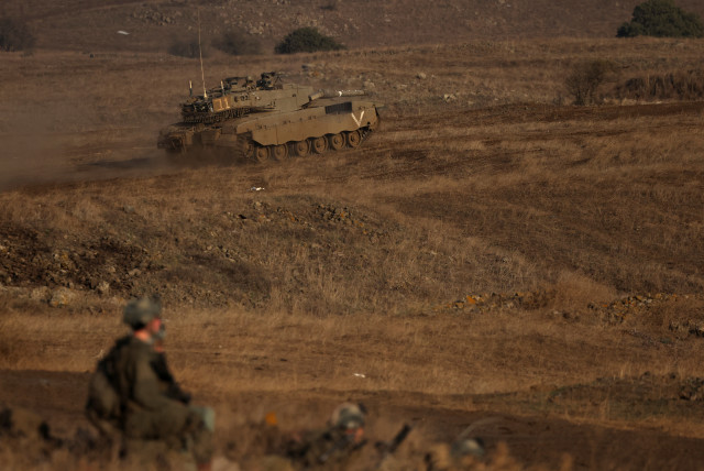 Israeli soldiers take part in a military drill near the border between Israel and Syria at the Golan Heights, November 2, 2023.  (credit: REUTERS/VIOLETA SANTOS MOURA)