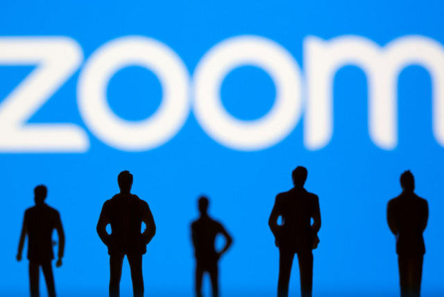  Small toy figures are seen in front of Zoom logo in this illustration picture taken March 15, 2021. (credit: REUTERS/DADO RUVIC/ILLUSTRATION)