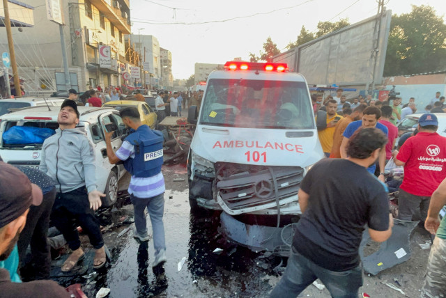 Palestinians check the damages after a convoy of ambulances was hit, at the entrance of Shifa hospital in Gaza City, November 3, 2023. (credit: REUTERS/MOHAMMED AL-MASRI)