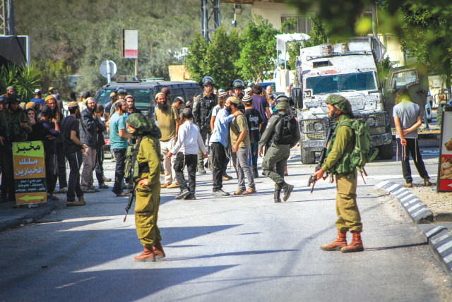  IDF SOLDIERS prevent settlers from entering the village of Deir Sharaf, west of Nablus, in response to a shooting attack last Thursday. (credit: NASSER ISHTAYEH/FLASH90)