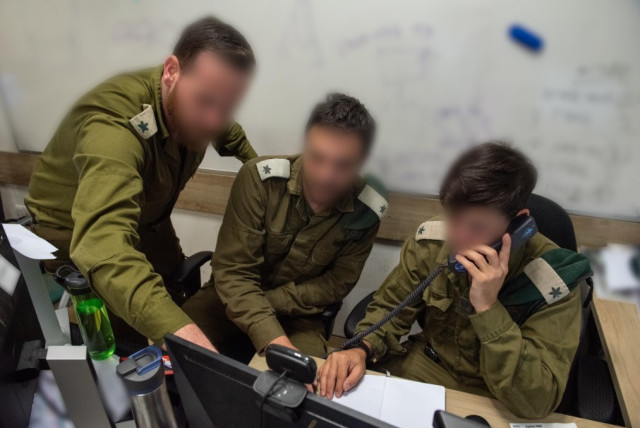  IDF soldiers are seen working as part of the Israeli military's Gaza battlefield intelligence collection unit. (credit: IDF SPOKESPERSON'S UNIT)