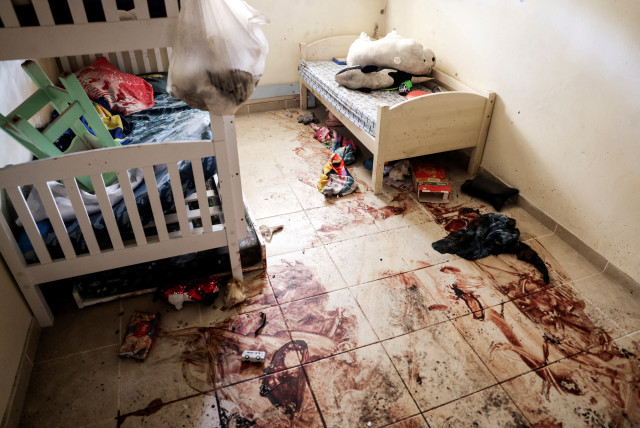  Children's toys and personal items lie on the bloodstained floor of a child's bedroom, following a deadly infiltration by Hamas terrorists from the Gaza Strip, in Kibbutz Beeri in southern Israel October 17, 2023. (credit: RONEN ZVULUN/REUTERS)