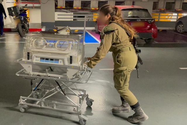  An IDF soldier moves an incubator to be delivered to Al-Shifa Hospital in Gaza. November 14, 2023. (credit: IDF)