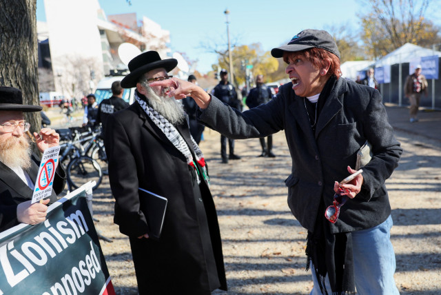  A woman yells at members of the Neturei Karta, a group opposed to Zionism and Israel, on the day of a rally in solidarity with Israel and against antisemitism, amid the ongoing war between Israel and Hamas, during a rally on the National Mall in Washington, US November 14, 2023. (credit: Leah Mills/Reuters)