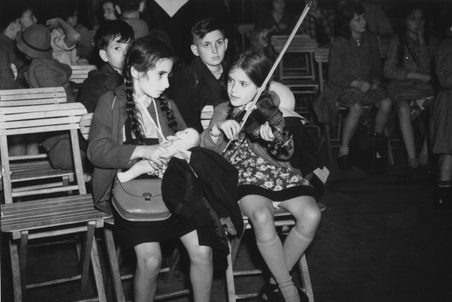  A YOUNG girl plays the violin – one of 150 Jewish refugee children to arrive from Berlin on the Kindertransport program at Liverpool Street station, 1939. (credit: Keystone/Hulton Archive/Getty Images)