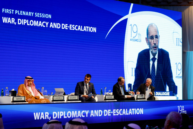  Delegates attend as Jordanian Foreign Minister Ayman Safadi appears on a screen while speaking at the IISS Manama Dialogue in Manama, Bahrain, November 18, 2023 (credit: REUTERS/HAMAD I MOHAMMED)