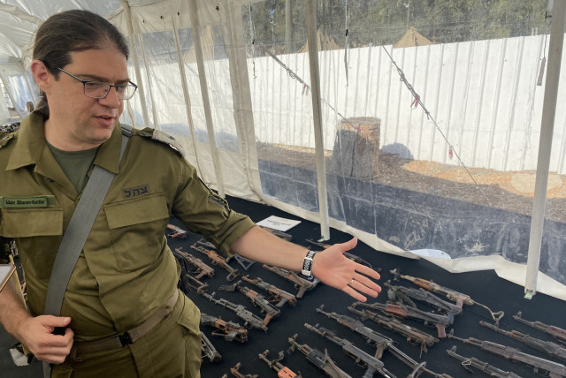  Lt. Col. (res.) Idan Sharon-Kettler speaks about the AK-47 rifles used by Hamas, on an IDF base in central Israel, Nov. 16, 2023.  (credit: Aaron Poris/The Media Line)
