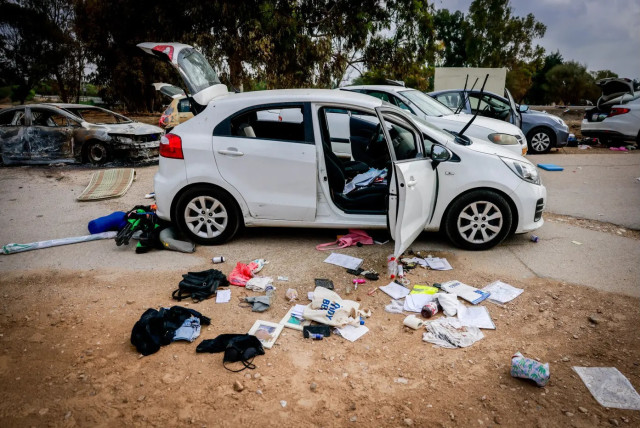Personal belongings near cars abandoned following the party in Kibbutz Re'im (credit: Chaim Goldberg/Flash90)