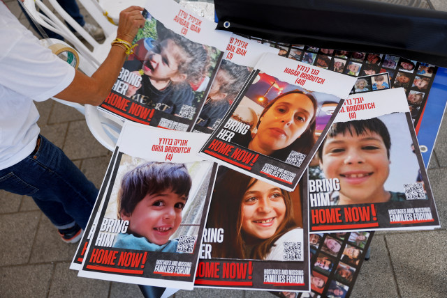  A supporter of the families of hostages who are being held in the Gaza Strip after they were seized by Hamas gunmen on October 7 prepares missing signs posters depicting hostages, in Tel Aviv, Israel November 21, 2023.  (credit: REUTERS/AMIR COHEN)