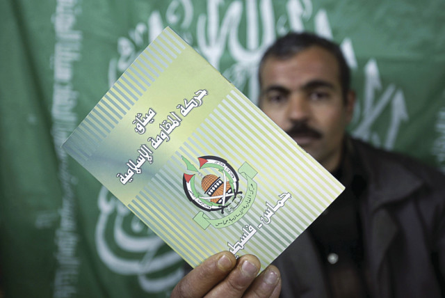 HAMAS CHARTER: A movement member in Gaza brandishes a copy.  (credit: Abid Katib/Getty Images)