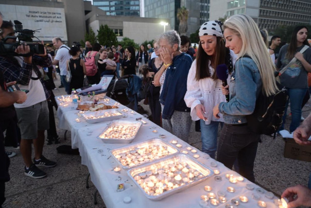 Family members of Israeli hostages lighting Shabbat candles in Tel Aviv ahead of release of 13 hostages (credit: AVSHALOM SASSONI/MAARIV)