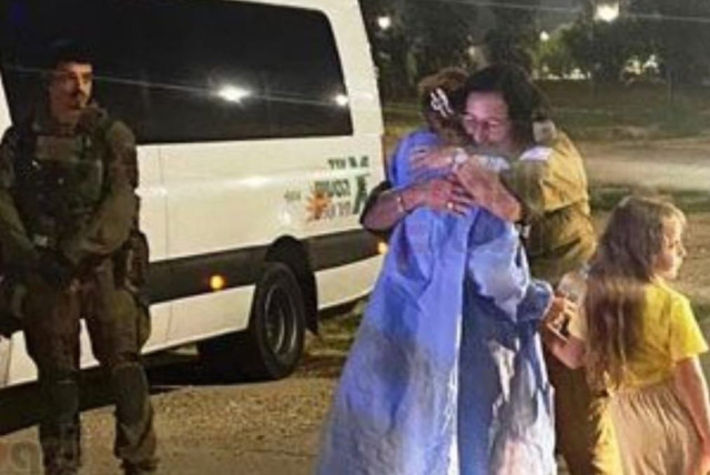  An Israeli hostage and her daughter are seen hugging an IDF officer amid their release from Hamas captivity on November 24, 2023 (credit: VIA MAARIV ONLINE)