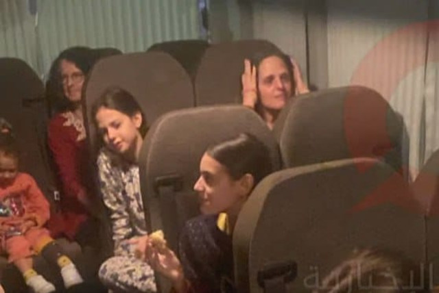  Israeli hostages, who had spent 50 days in captivity in Gaza, are seen on a bus returning to Israel after their release on Saturday, November 25, 2023. (credit: screenshot)
