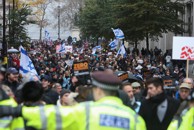 Demonstrators wave Israeli flags at a march against the rise of antisemitism in the UK, during a temporary truce between the Palestinian terrorist group Hamas and Israel, in London, Britain November 26, 2023. (credit: Susannah Ireland/Reuters)