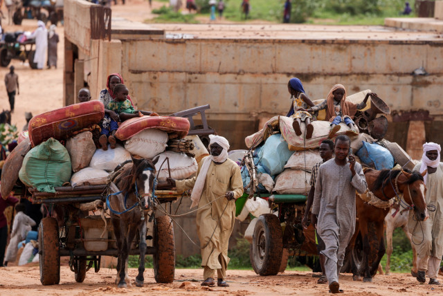 Chadian cart owners transport belongings of Sudanese people who fled the conflict in Sudan's Darfur region, while crossing the border between Sudan and Chad in Adre, Chad August 4, 2023. (credit: REUTERS/ZOHRA BENSEMRA/FILE PHOTO)