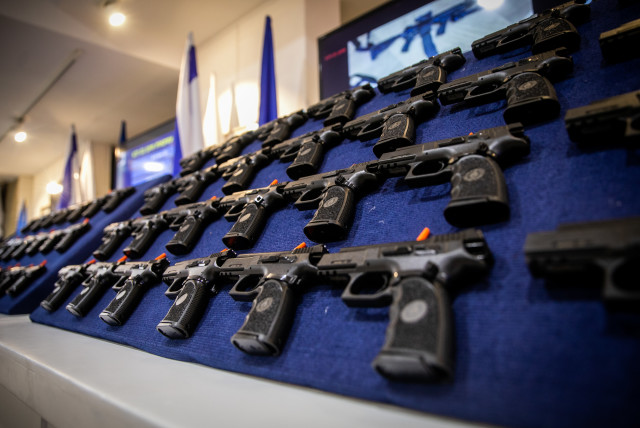  Illegal weapons are displayed during a ceremony in Ma'ale Adumim, after a large police operation against illegal gun dealers, September 7, 2022. (credit: OREN BEN HAKOON/FLASH90)